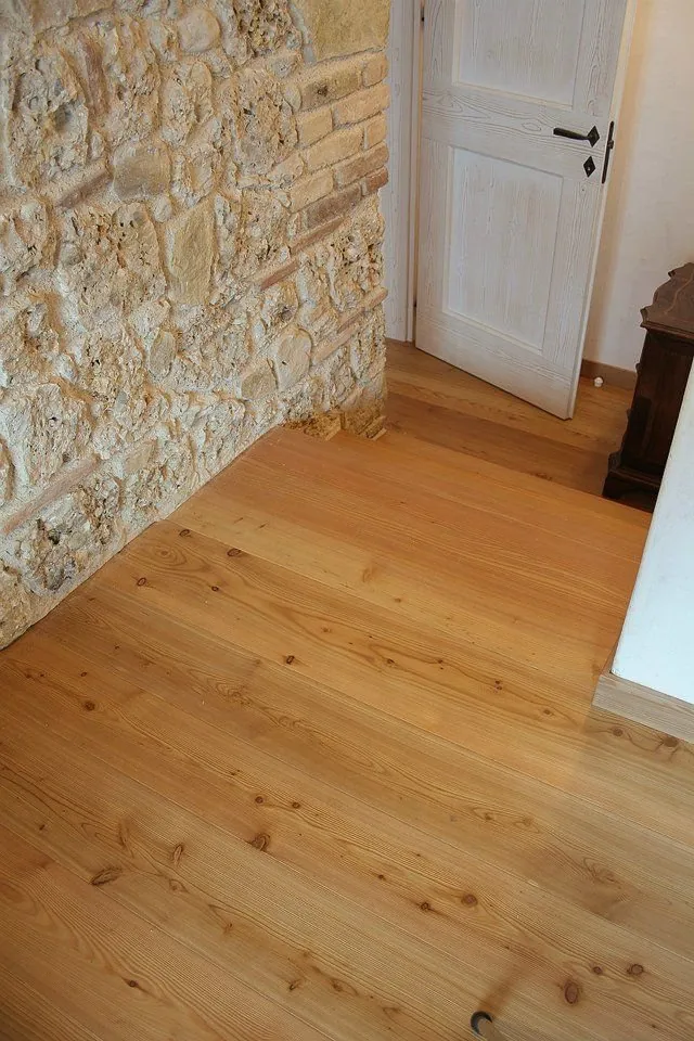 Parquet in legno chiaro accostato a muro in pietra — Latina e Roma